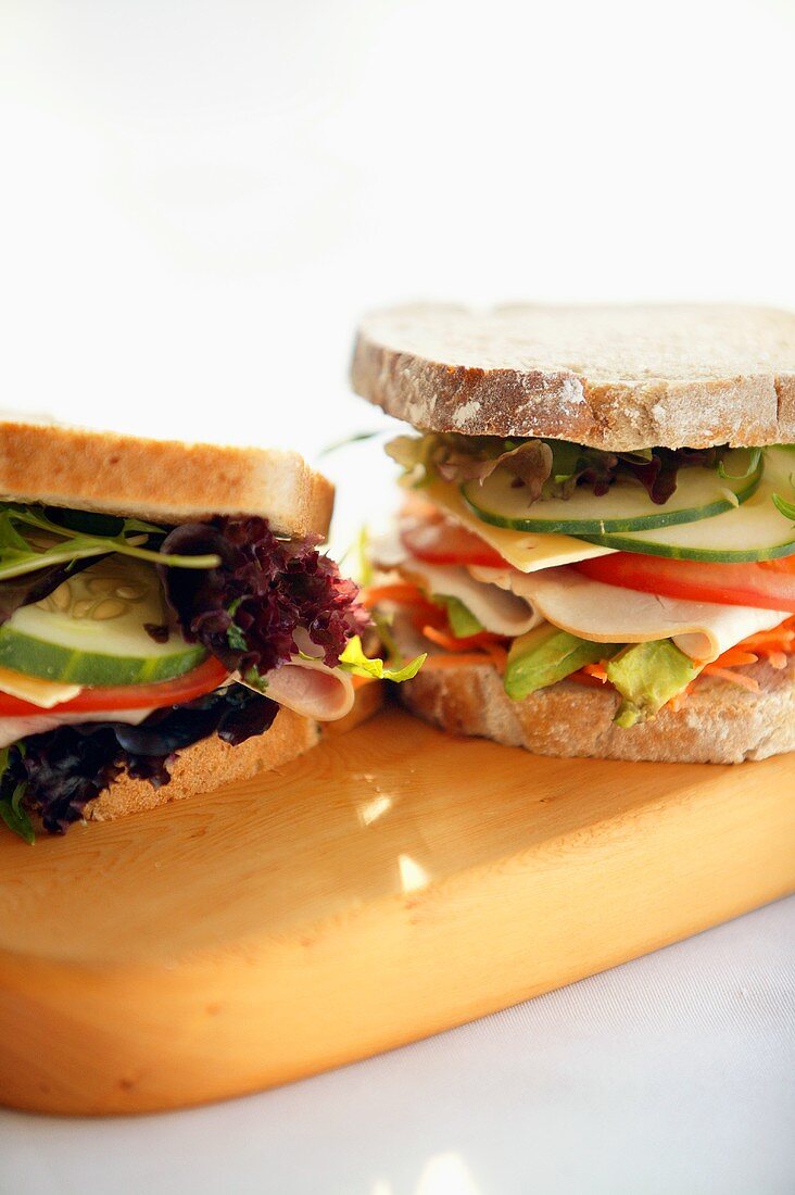 Two sandwiches on chopping board