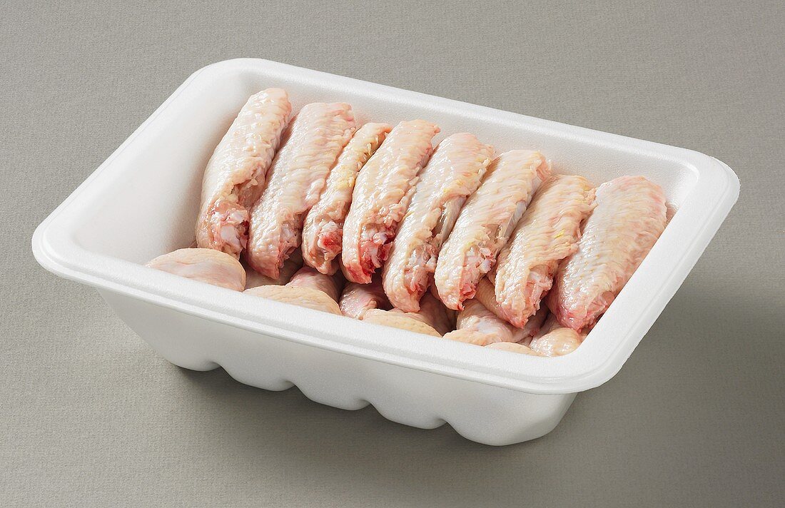 Chicken pieces in plastic container