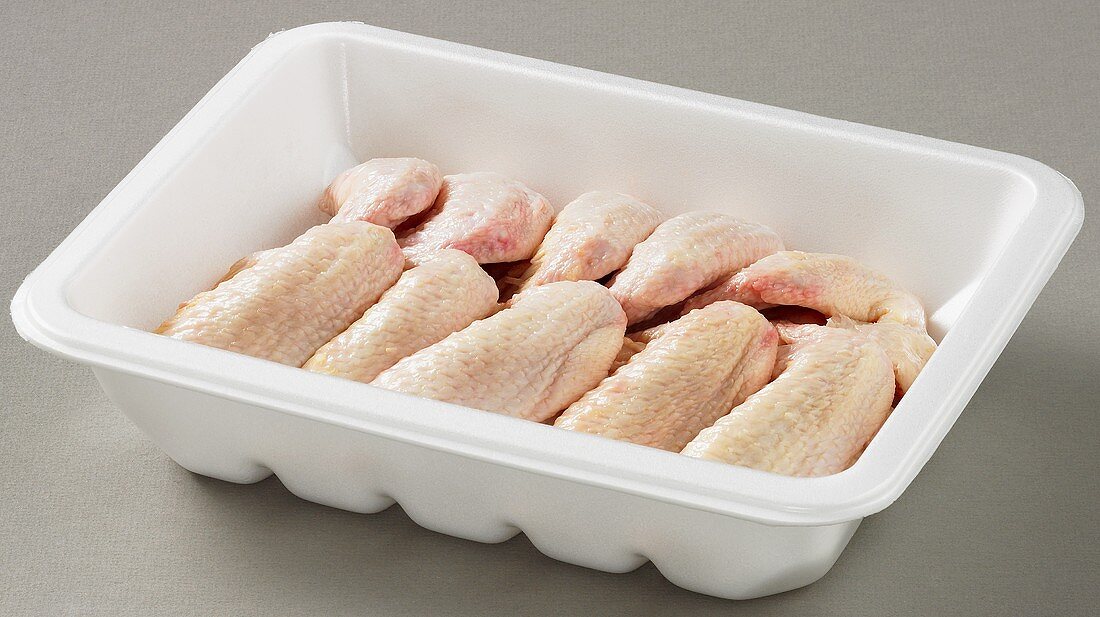 Whole chicken wings in plastic container