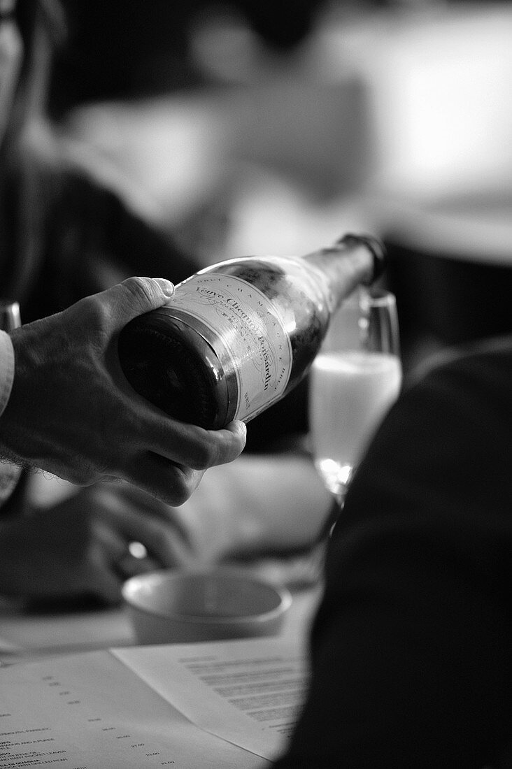 Pouring sparkling wine in a restaurant