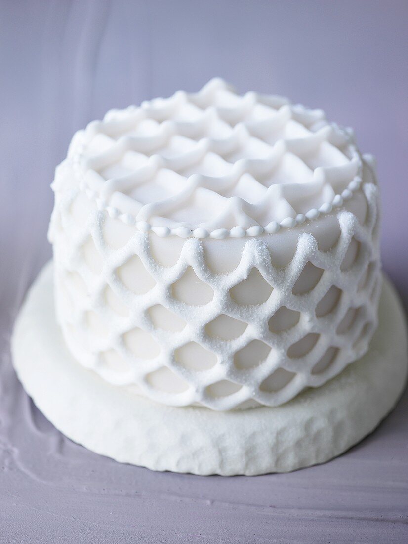 Small white cake with lattice decoration
