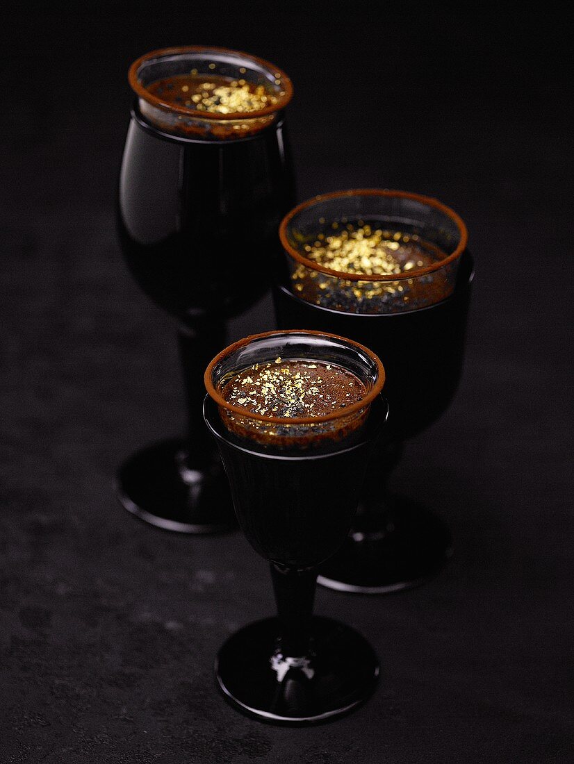 Chocolate cream with gold leaf in three glasses
