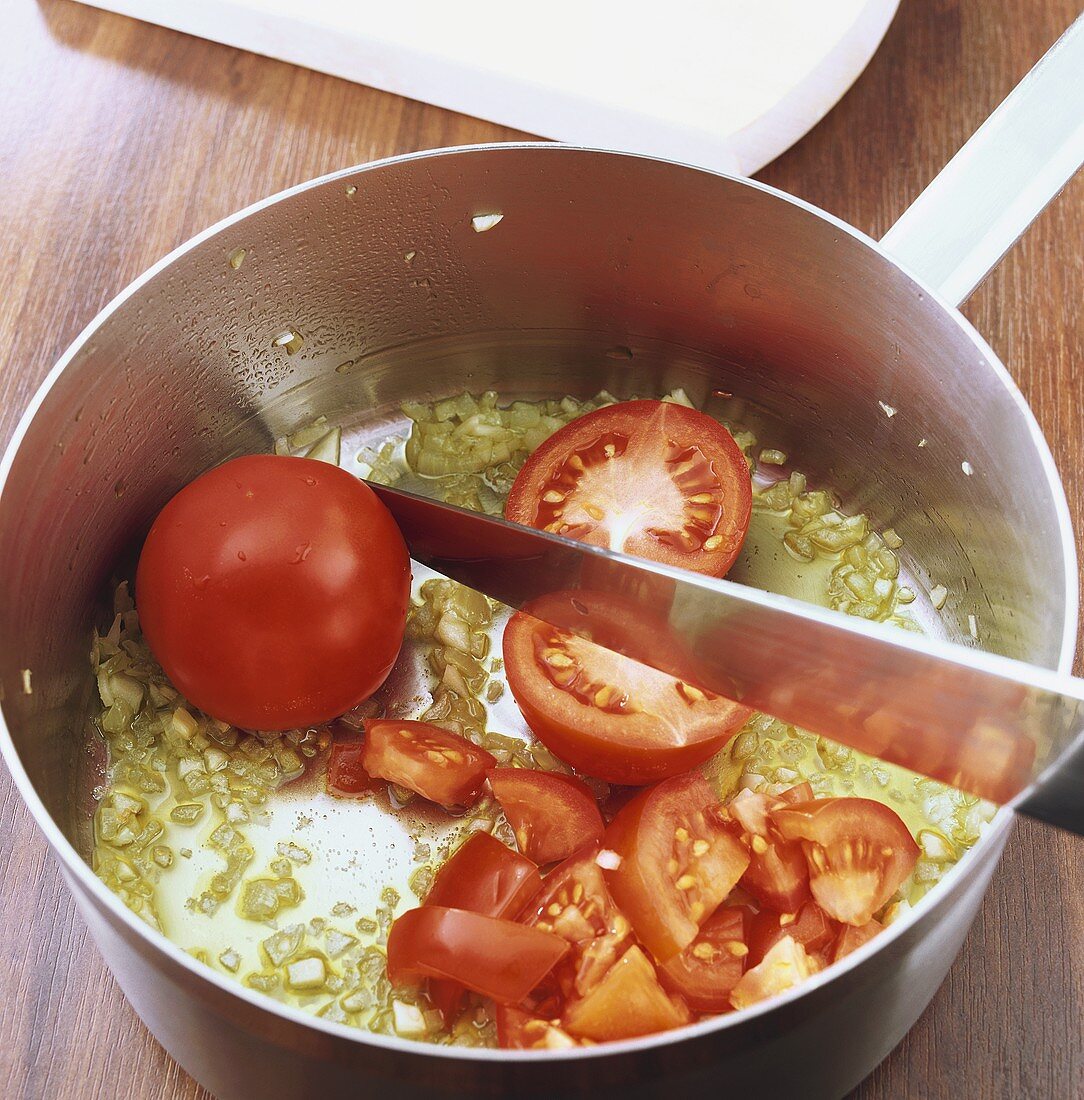 Making tomato sauce: chopping tomatoes