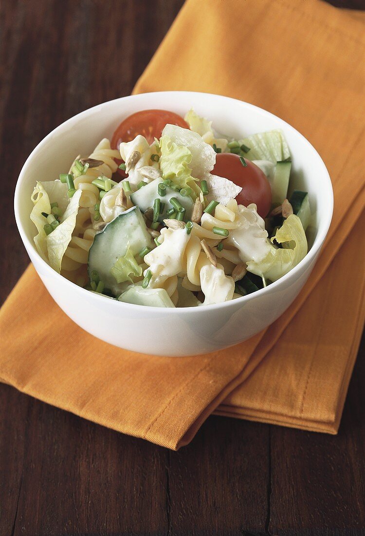 Pasta salad with vegetables, yoghurt dressing & sunflower seeds
