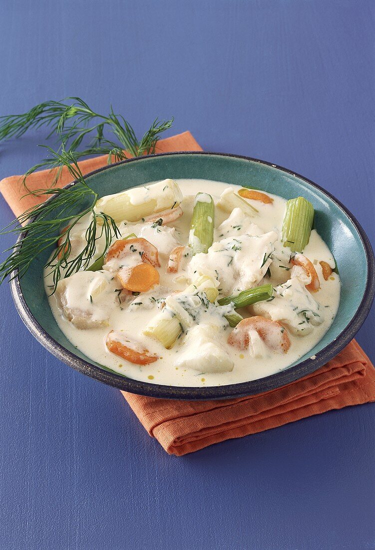 Fish ragout with cream, carrots and spring onions