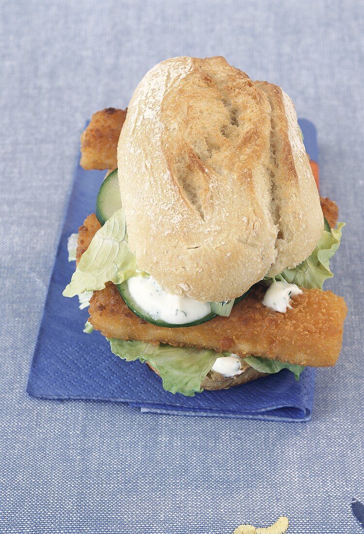 Fish fingers in baguette with cucumber and lettuce