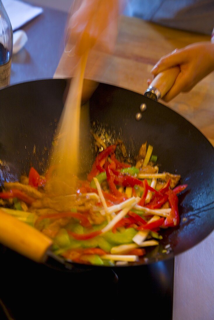 Stir-frying vegetables in a wok