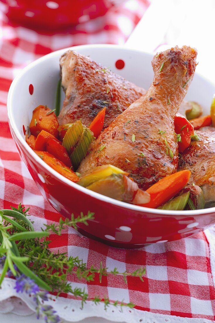 Chicken legs marinated in red wine with carrots and celery