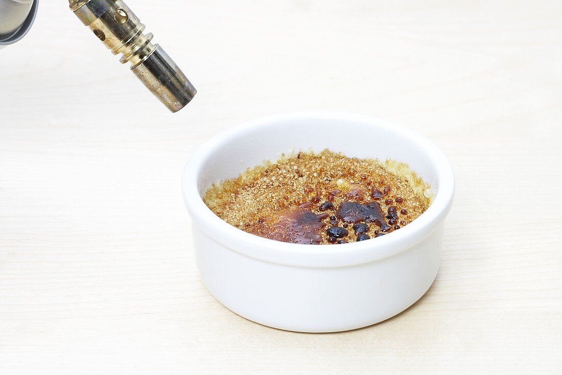 Caramelising crème brûlée with a blowtorch