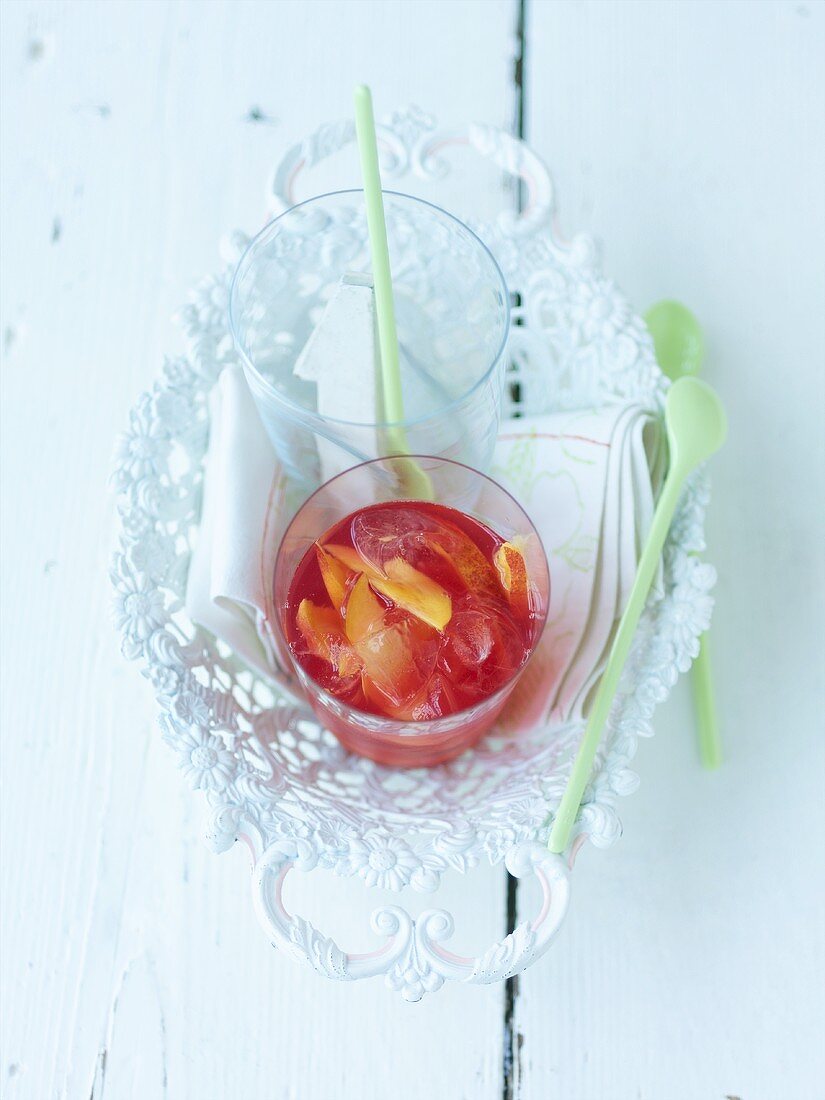 Cranberry drink with nectarine slices