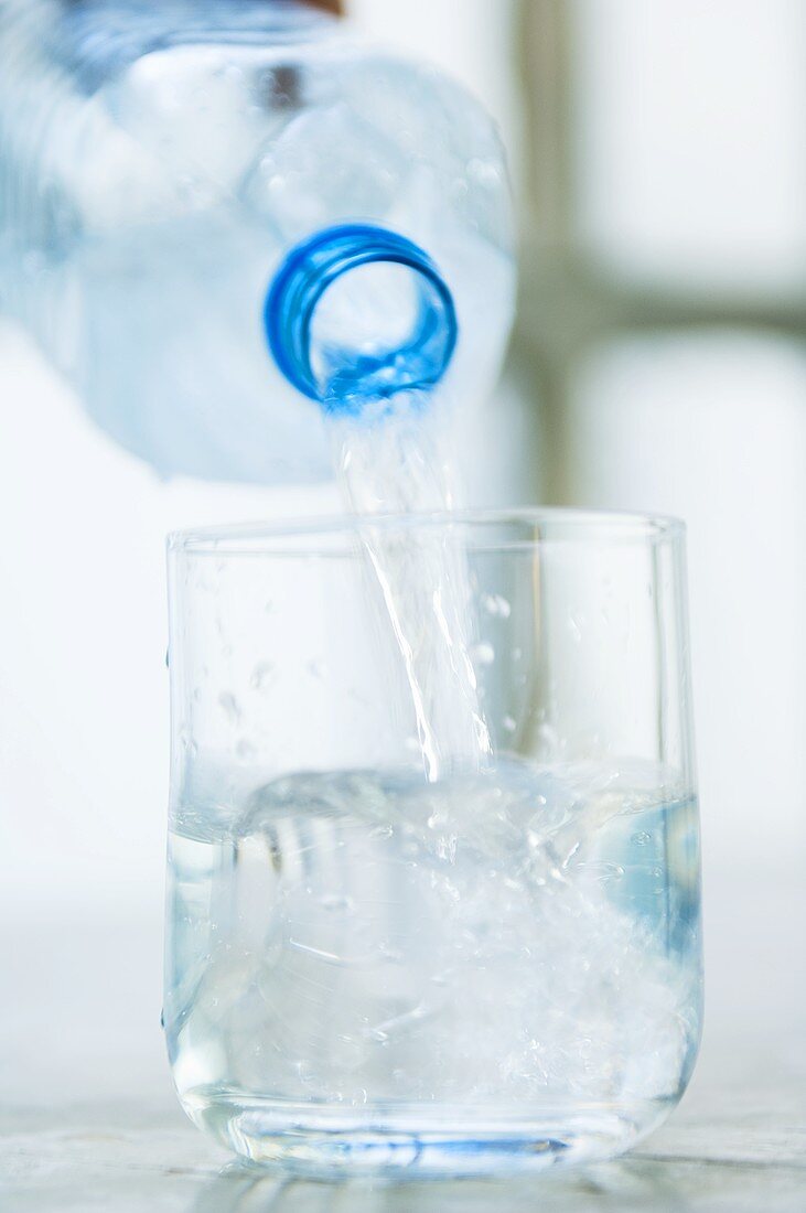 Pouring water into a glass