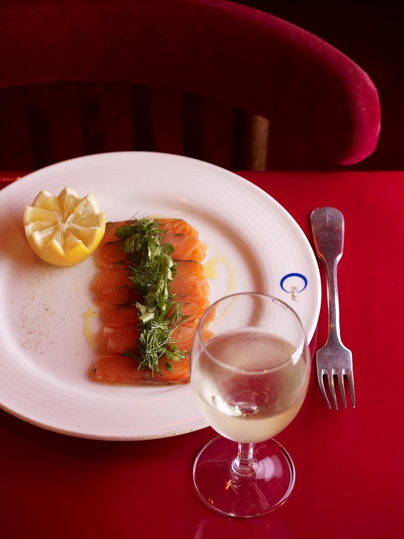 Salmon fillet with herbs, glass of white wine