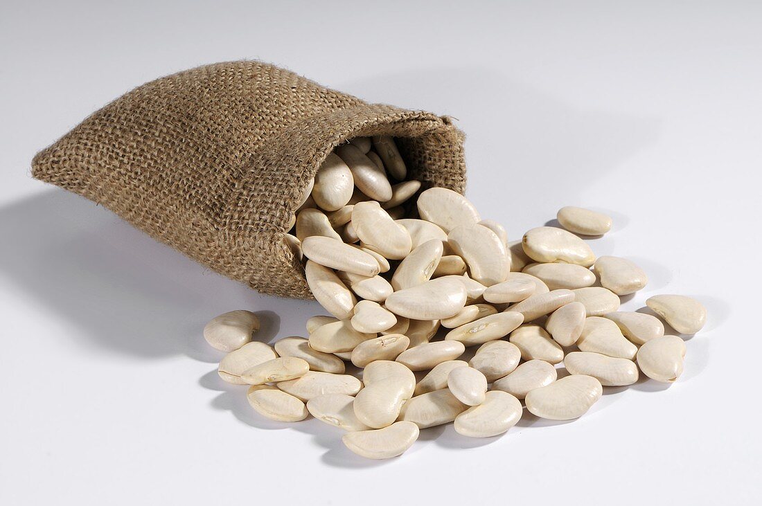 White beans spilling out of hessian sack