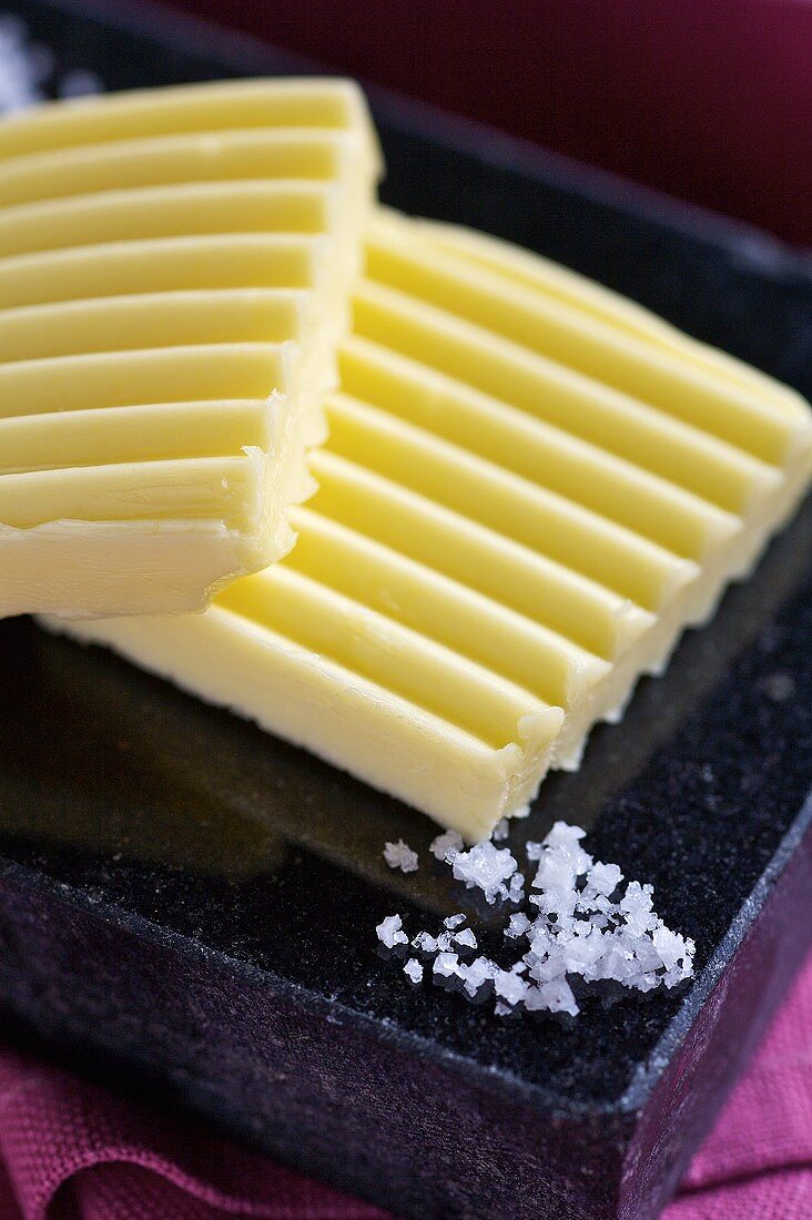 Slices of butter and salt crystals