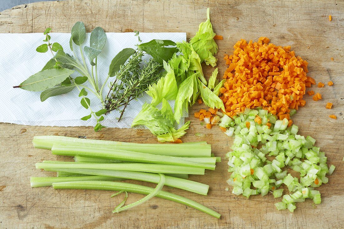 Ingredients for tomato sugo (celery, herbs, carrot, onion)