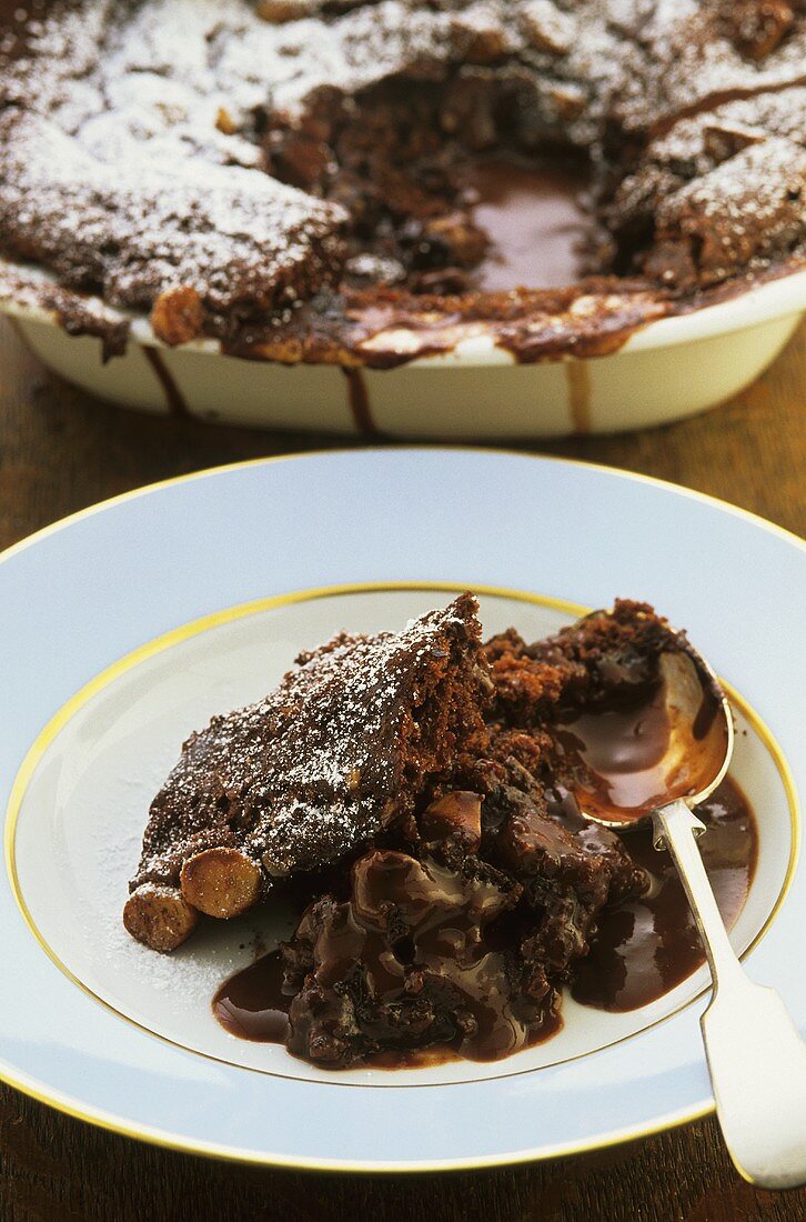 Chocolate macadamia pudding with icing sugar