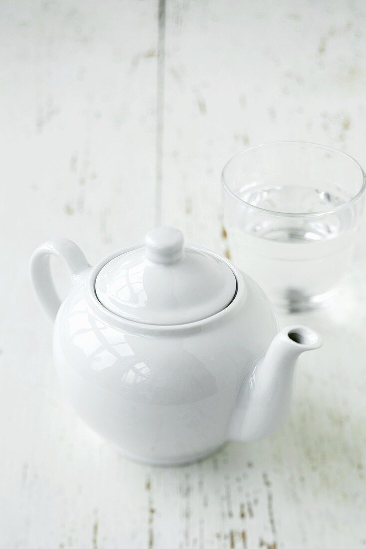 A teapot and a glass of water