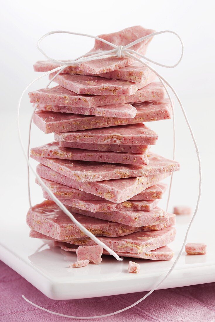 Pieces of raspberry crunch chocolate, stacked