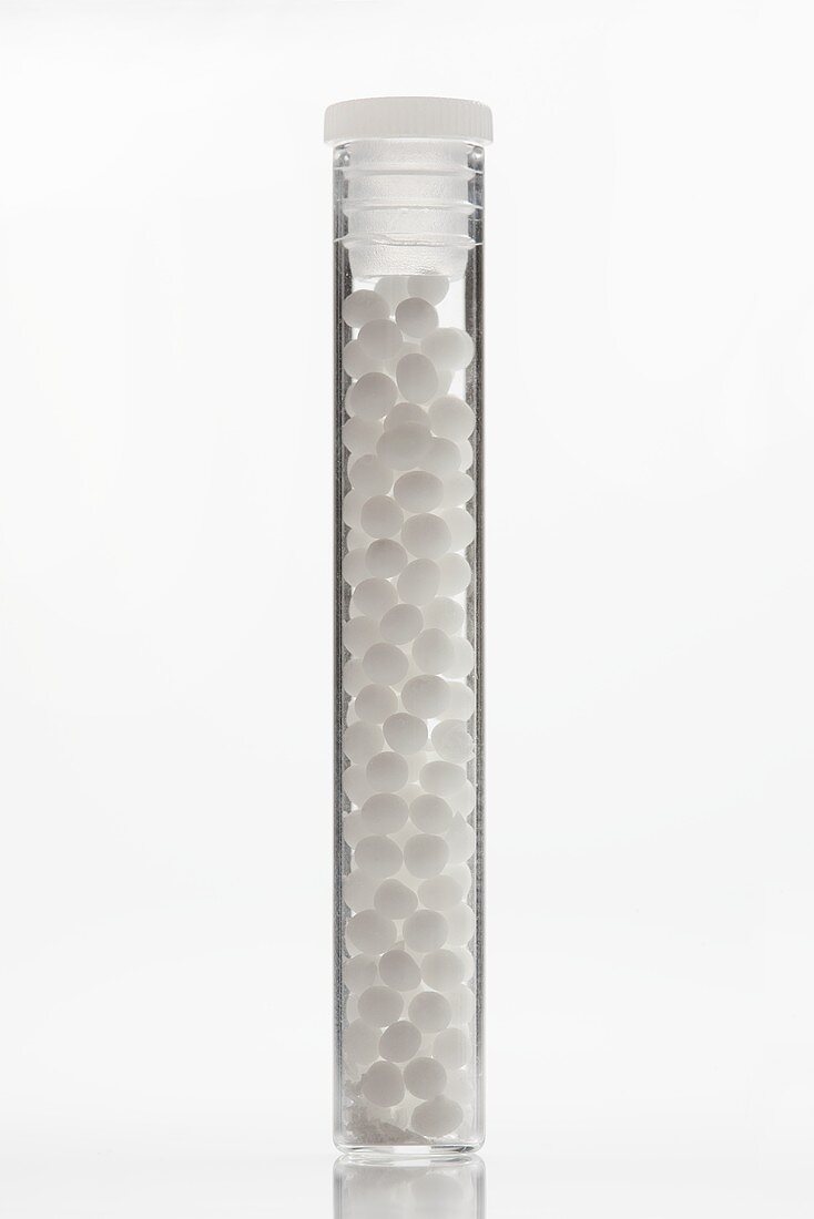 Globuli (homeopathic pellets) in glass tube