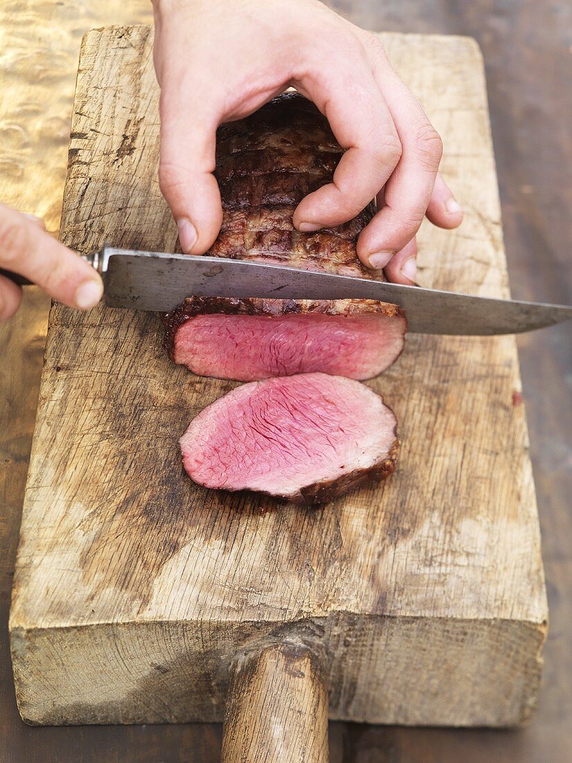 Slicing barbecued beef fillet