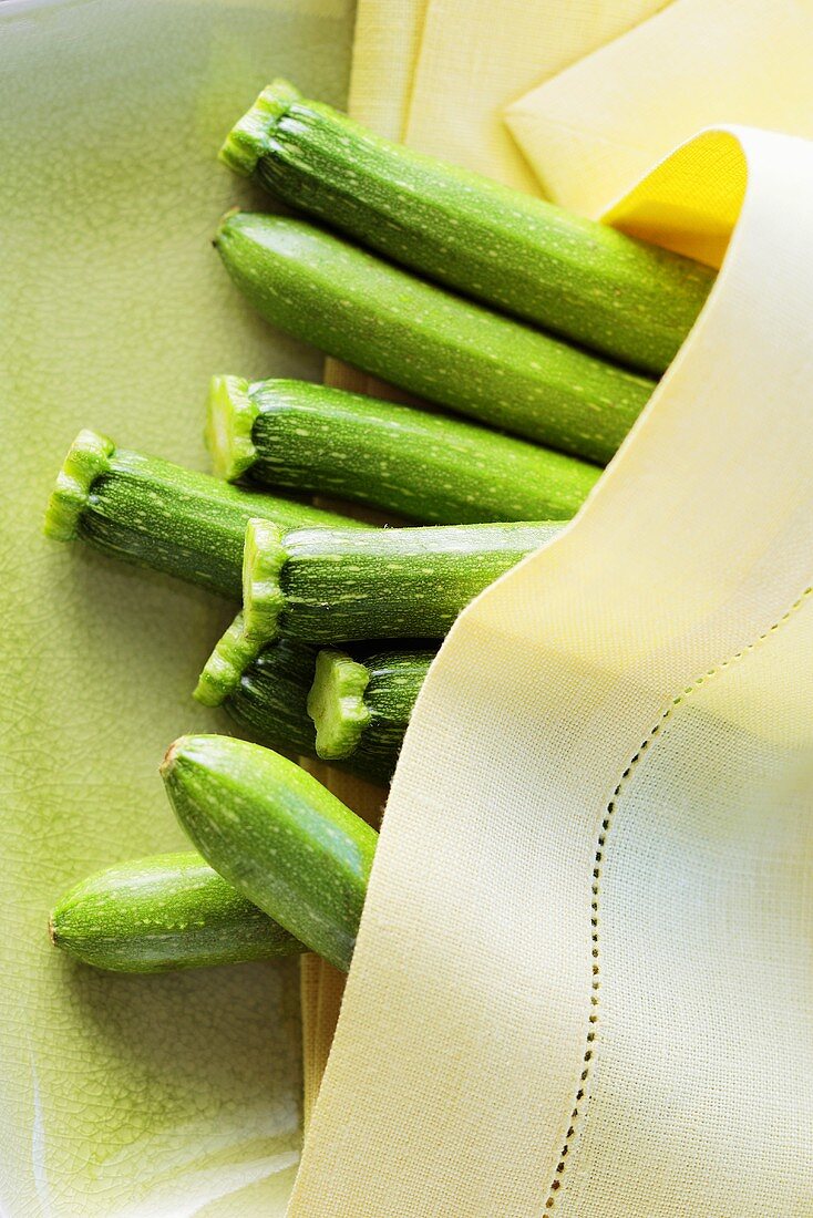 Several courgettes between cloths