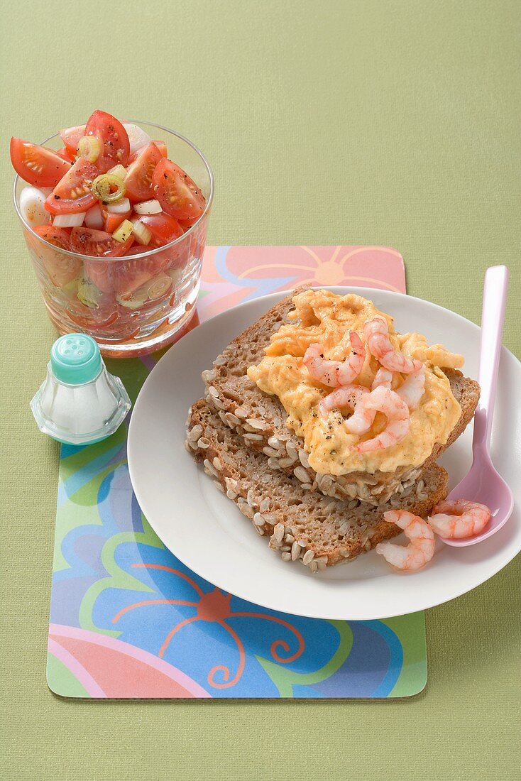 Scrambled egg with shrimps, cherry tomato salad