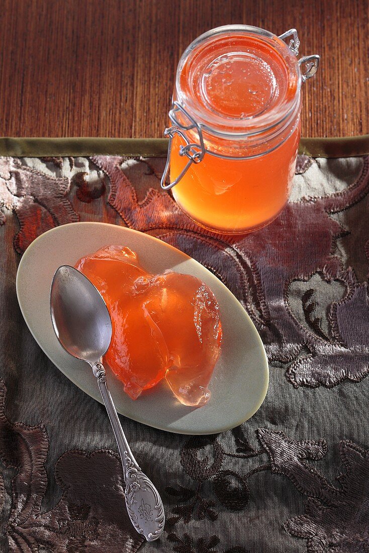 Quince jelly on plate and in preserving jar