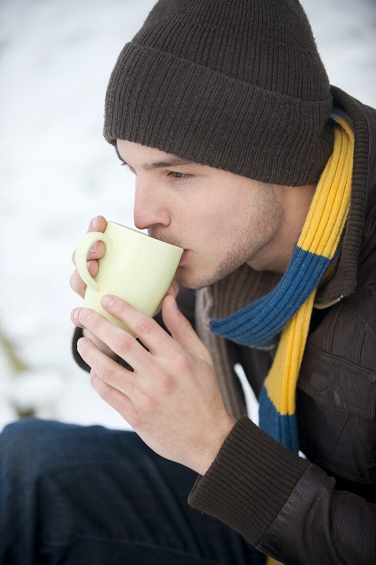 Young man drinking cocoa