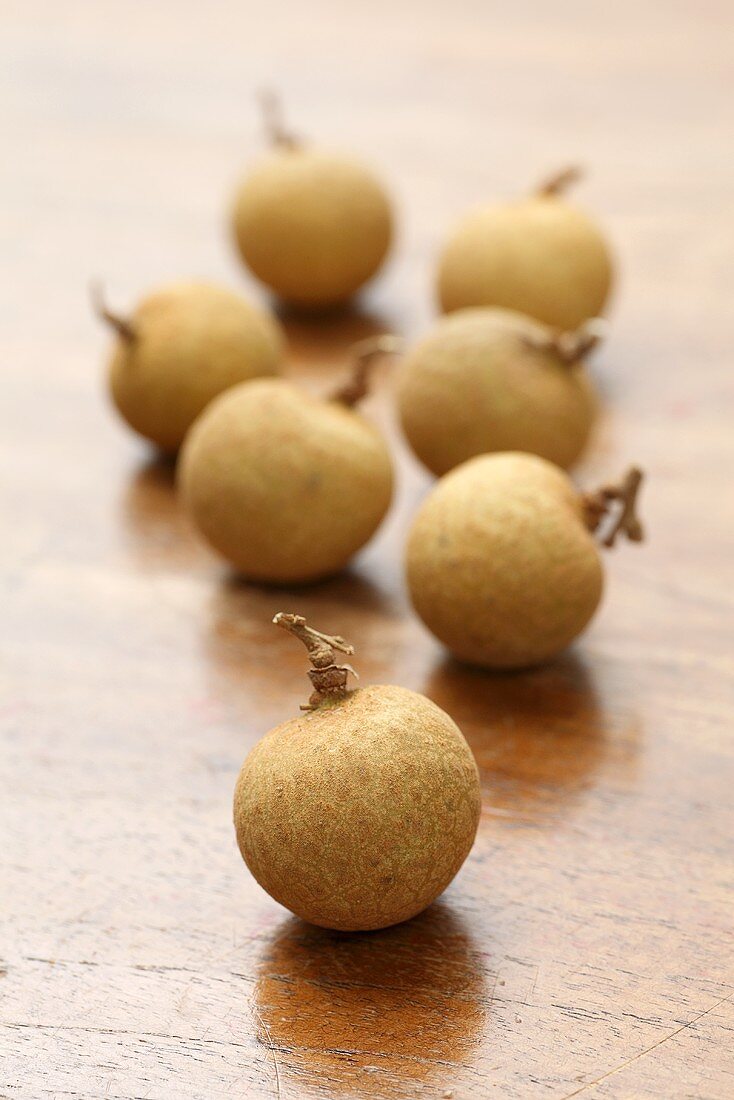 Several longans on wooden background