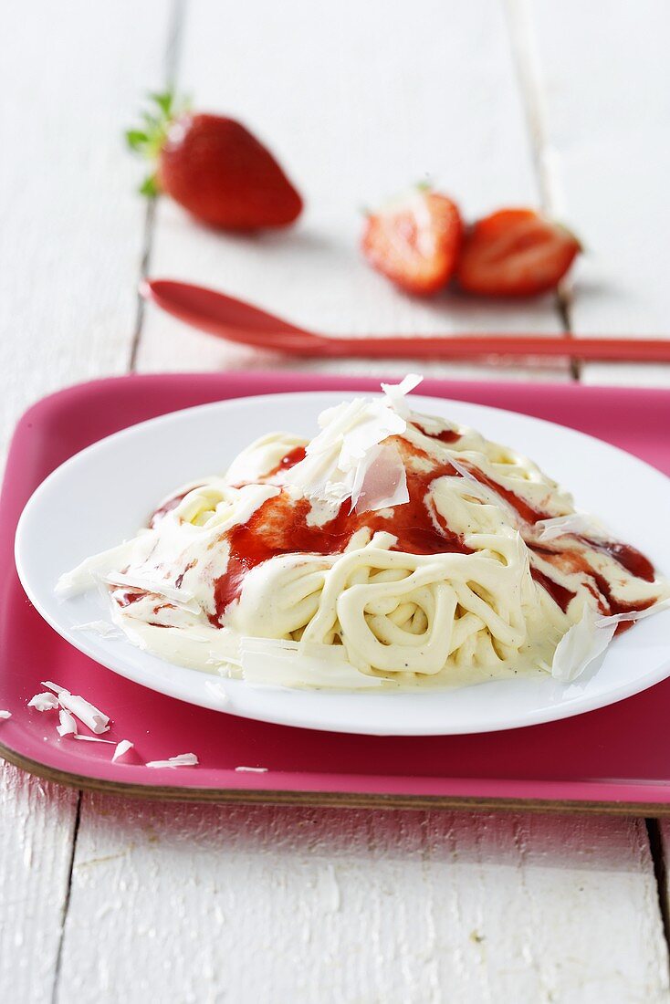 Spaghetti ice cream with strawberry sauce