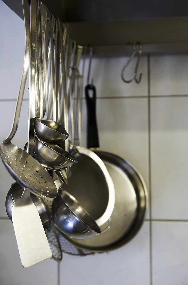 Assorted kitchen utensils, hanging up