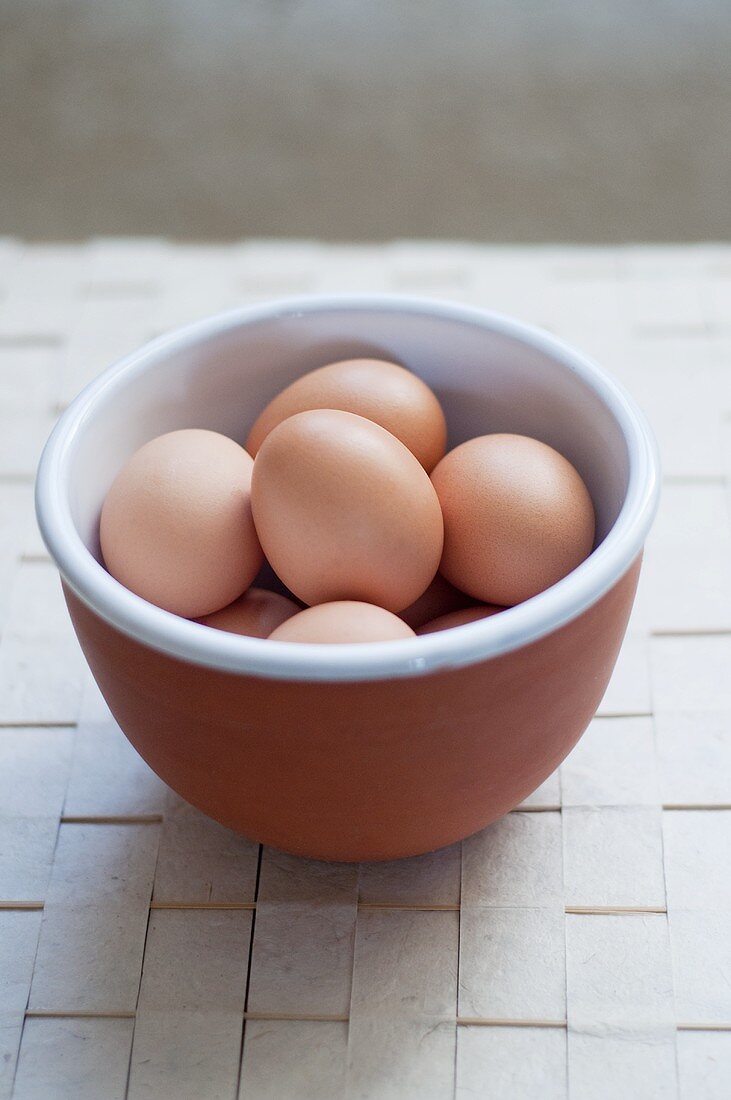 Brown eggs in ceramic bowl
