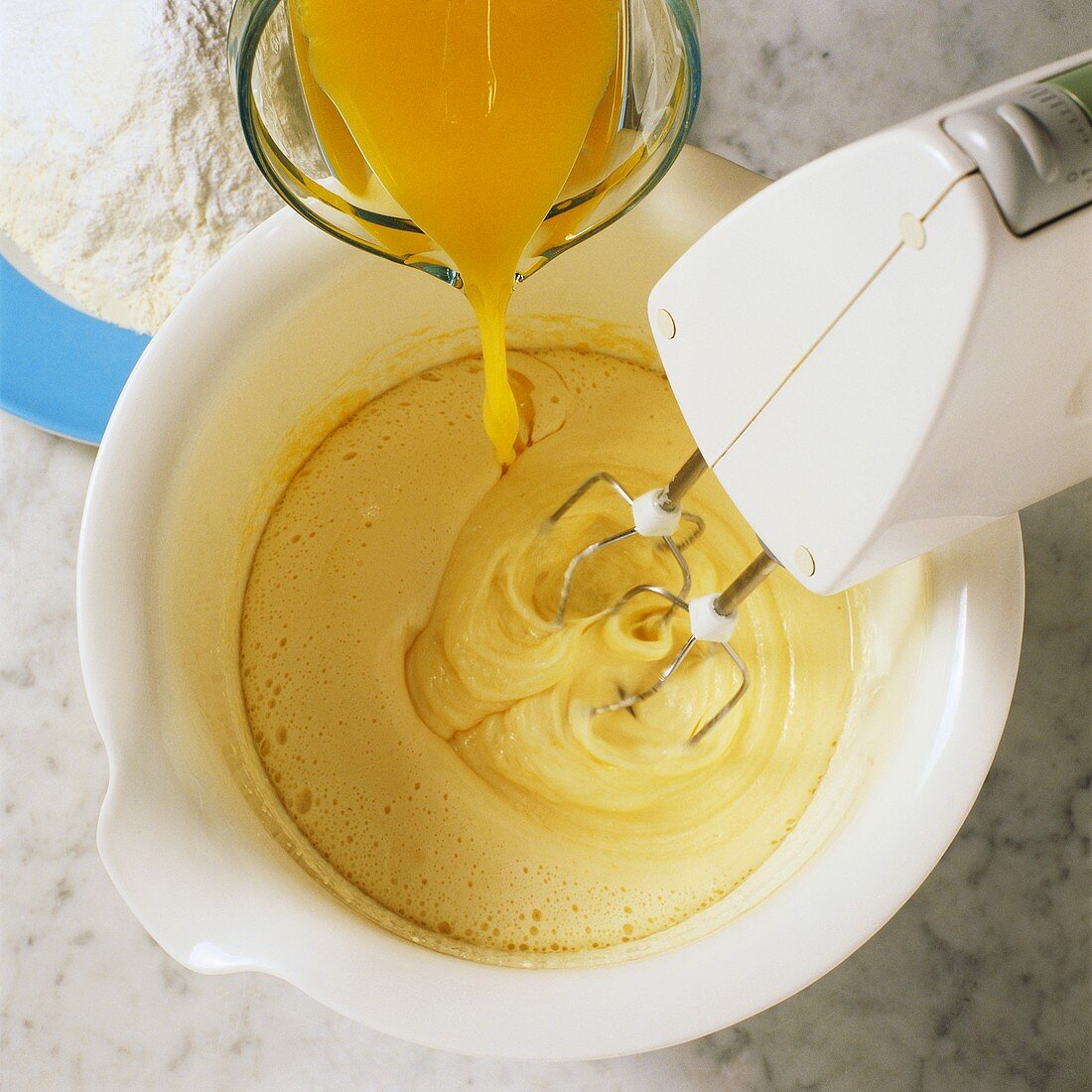 Making cake mixture: mixing oil with juice
