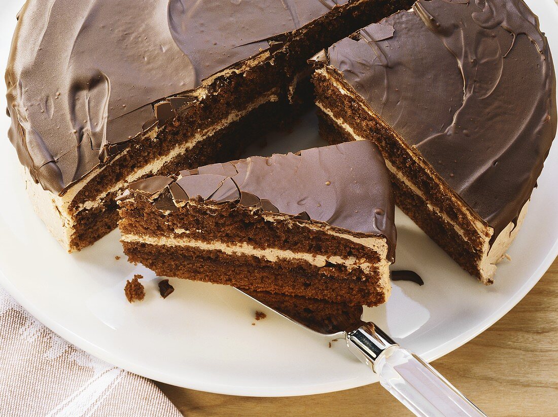 Chocolate cream cake, partly sliced
