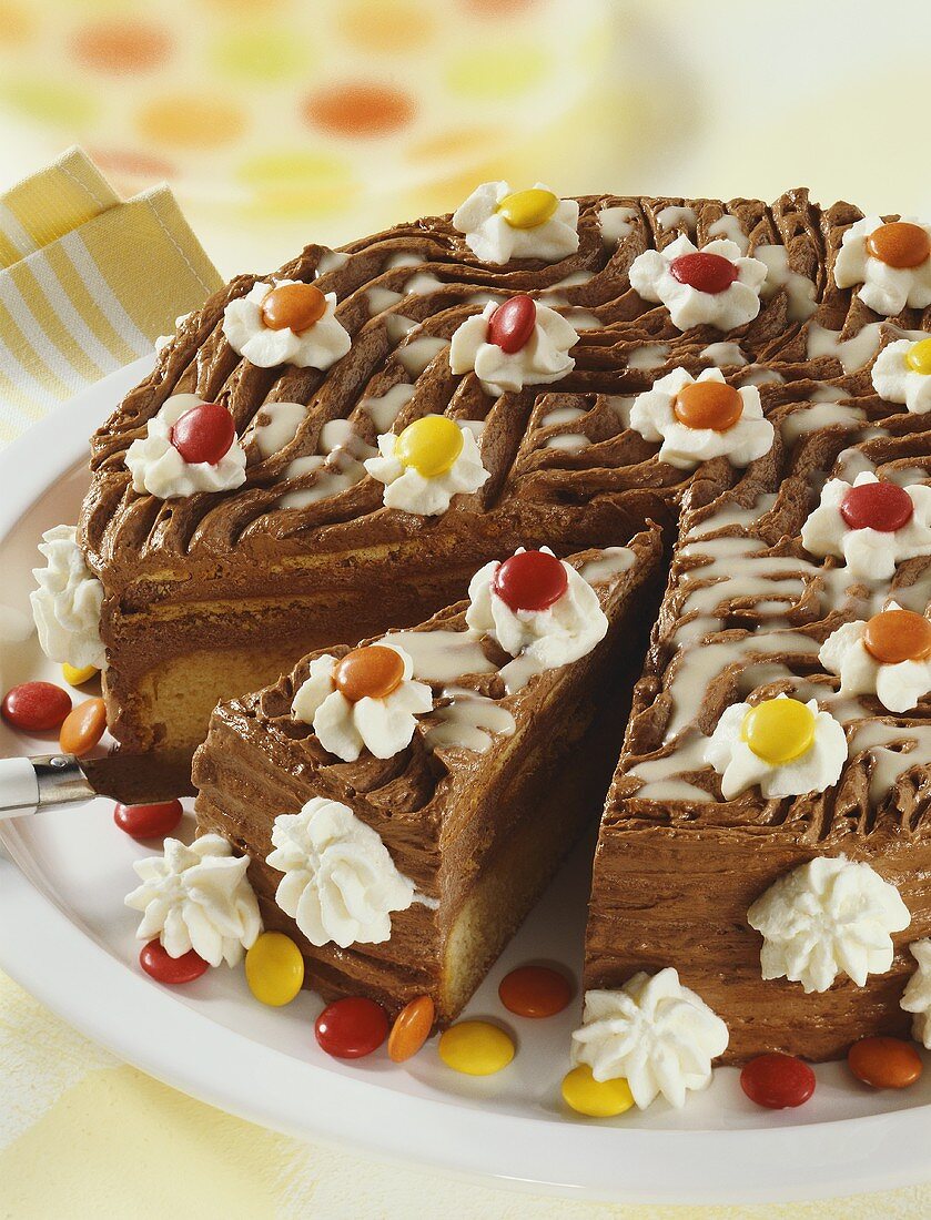 Chocolate cake with cream and coloured chocolate beans