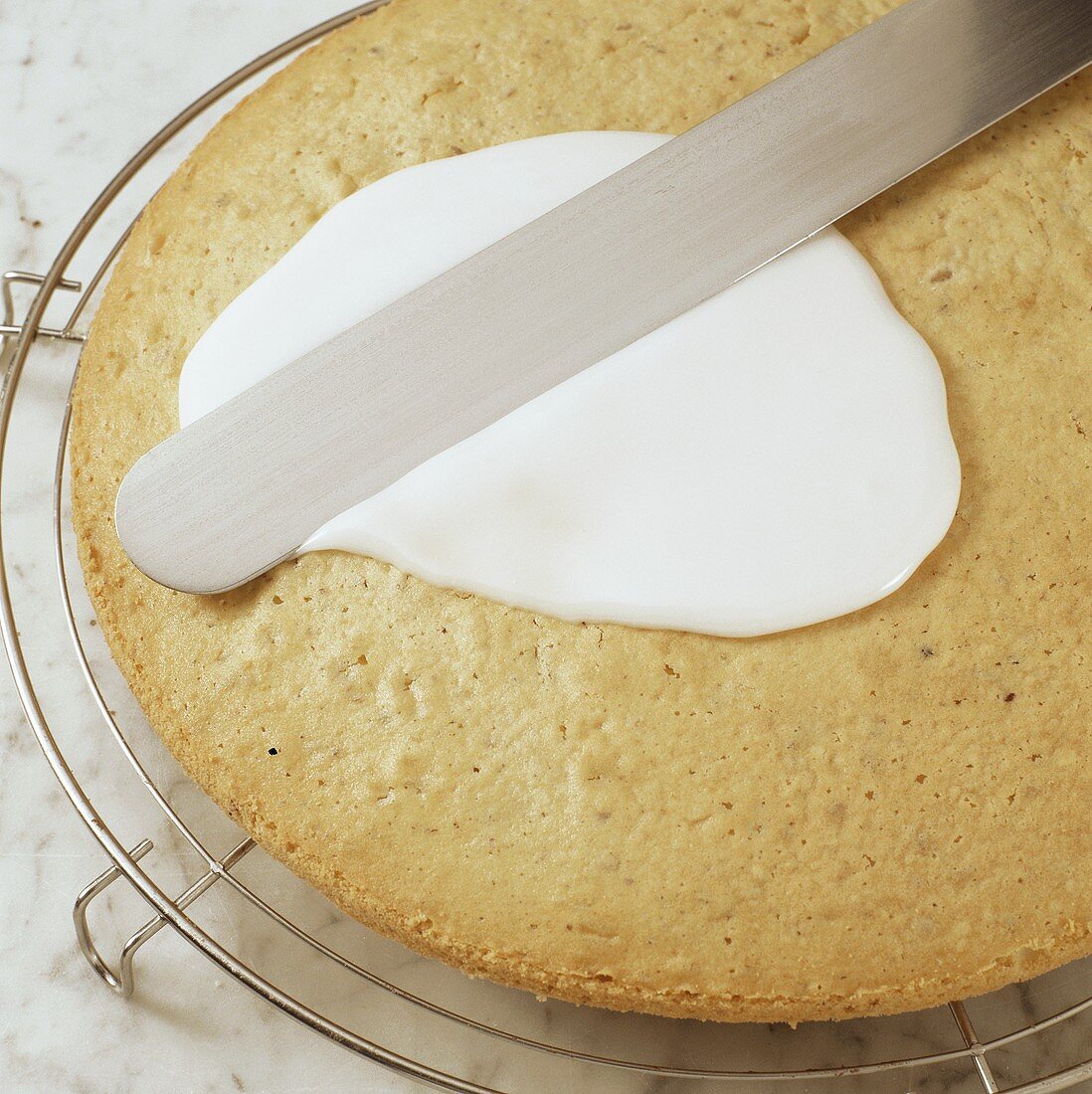 Coating a cake with glacé icing