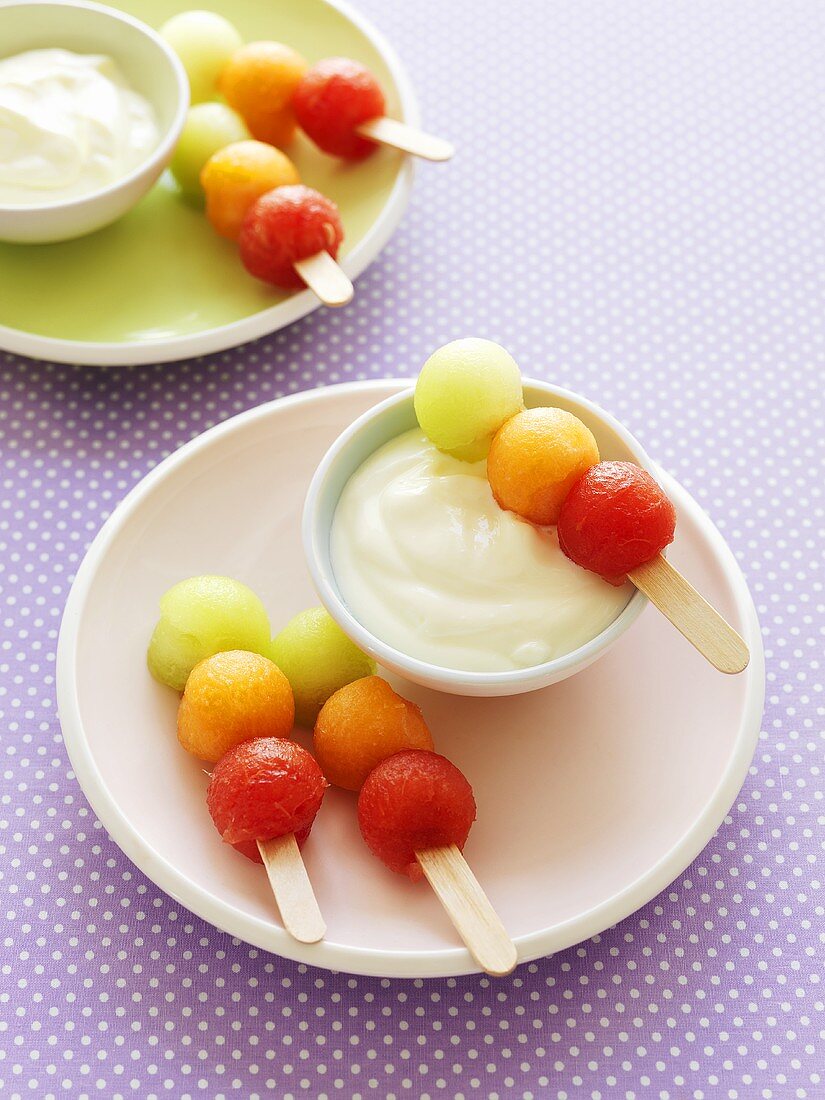 Melon balls on sticks with yoghurt dip