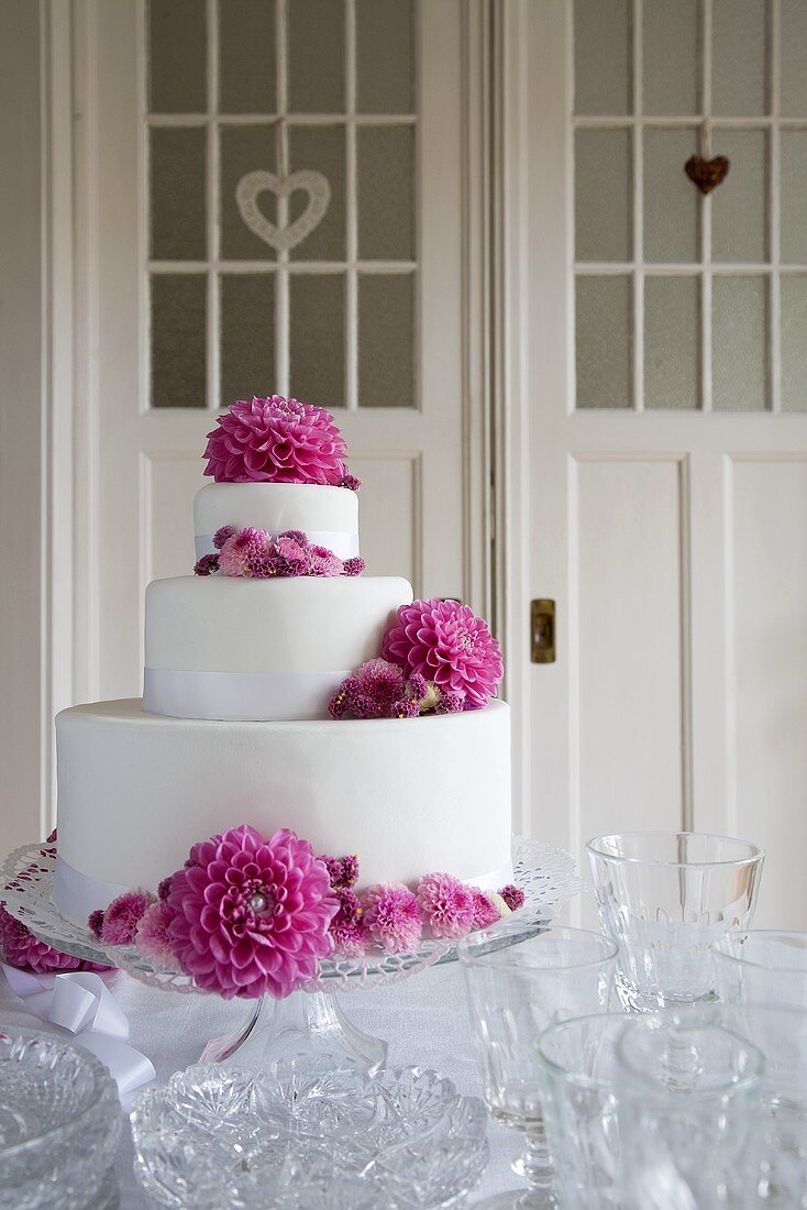 Three-tier wedding cake with decorated with flowers