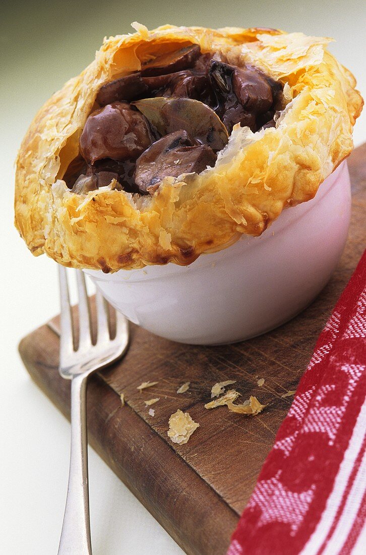 Mushroom ragout in red wine sauce with puff pastry crust