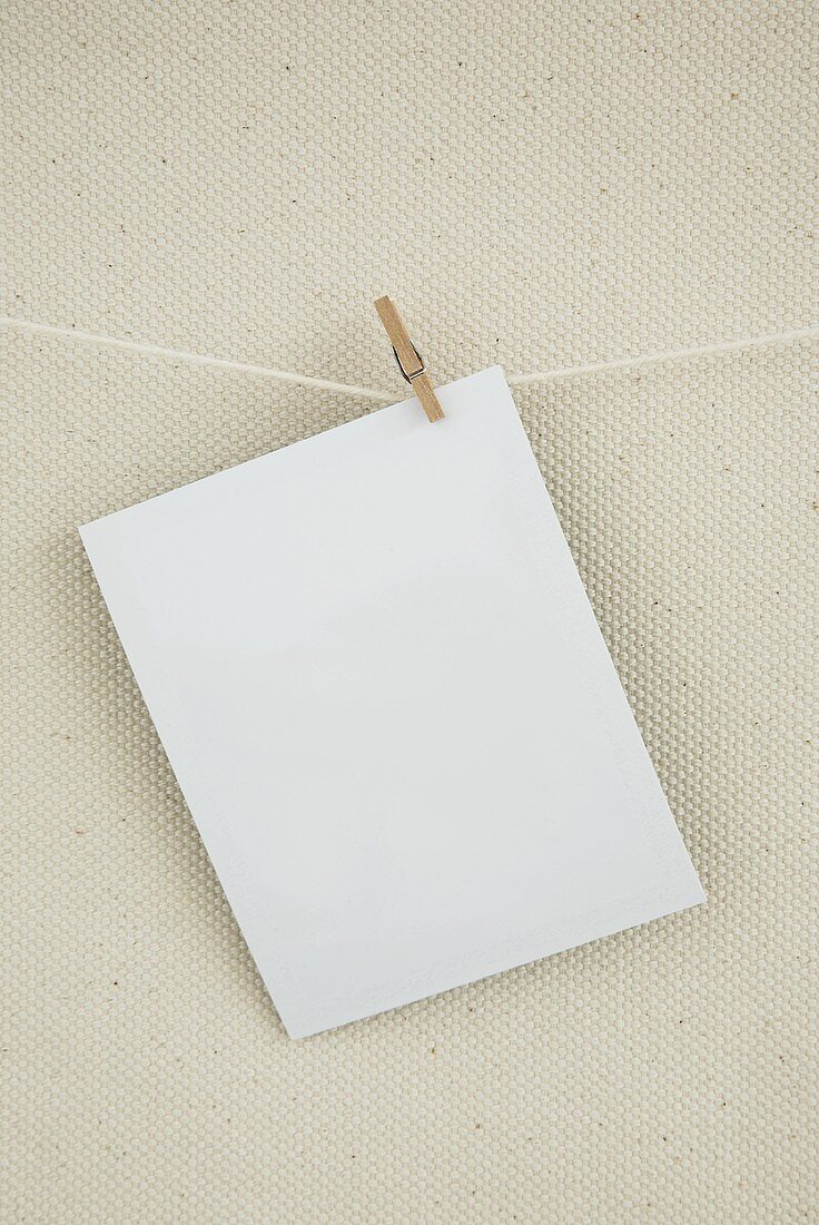 A sheet of paper on a washing line