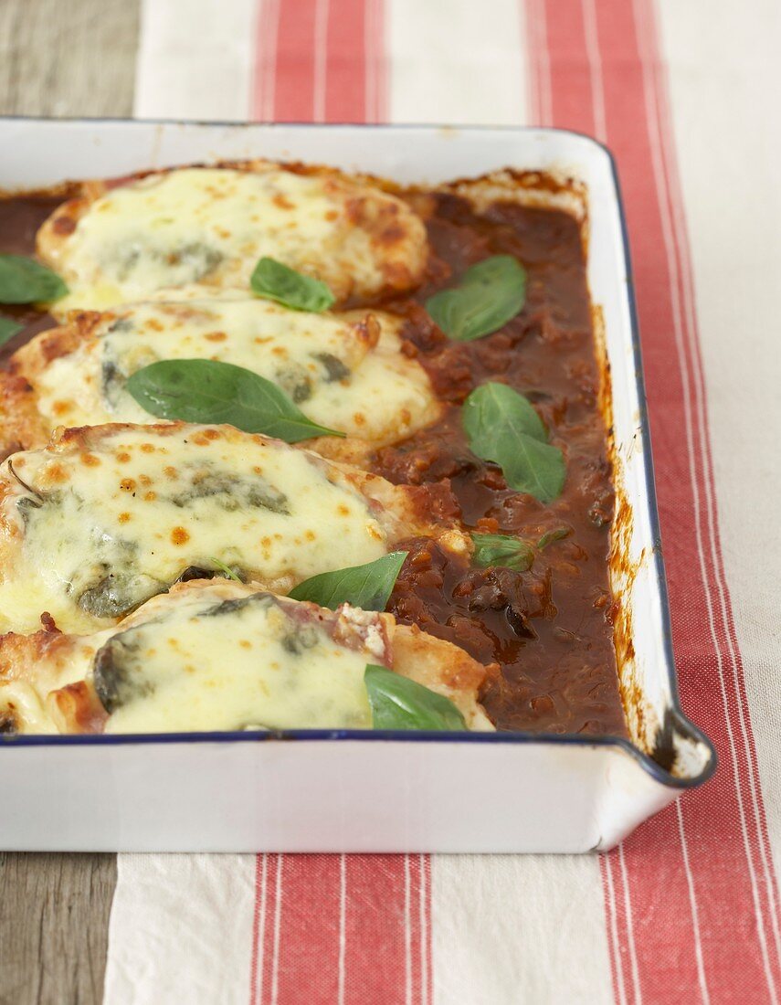 Baked chicken breast fillets in tomato sauce with mozzarella