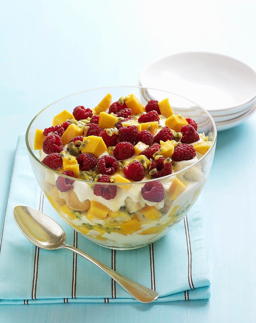 Trifle with cream, mango, passion fruit and raspberries