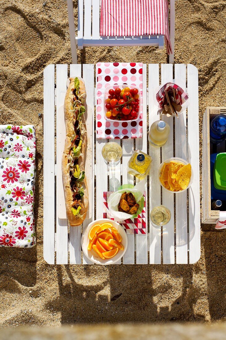 Laid table with filled baguette out of doors