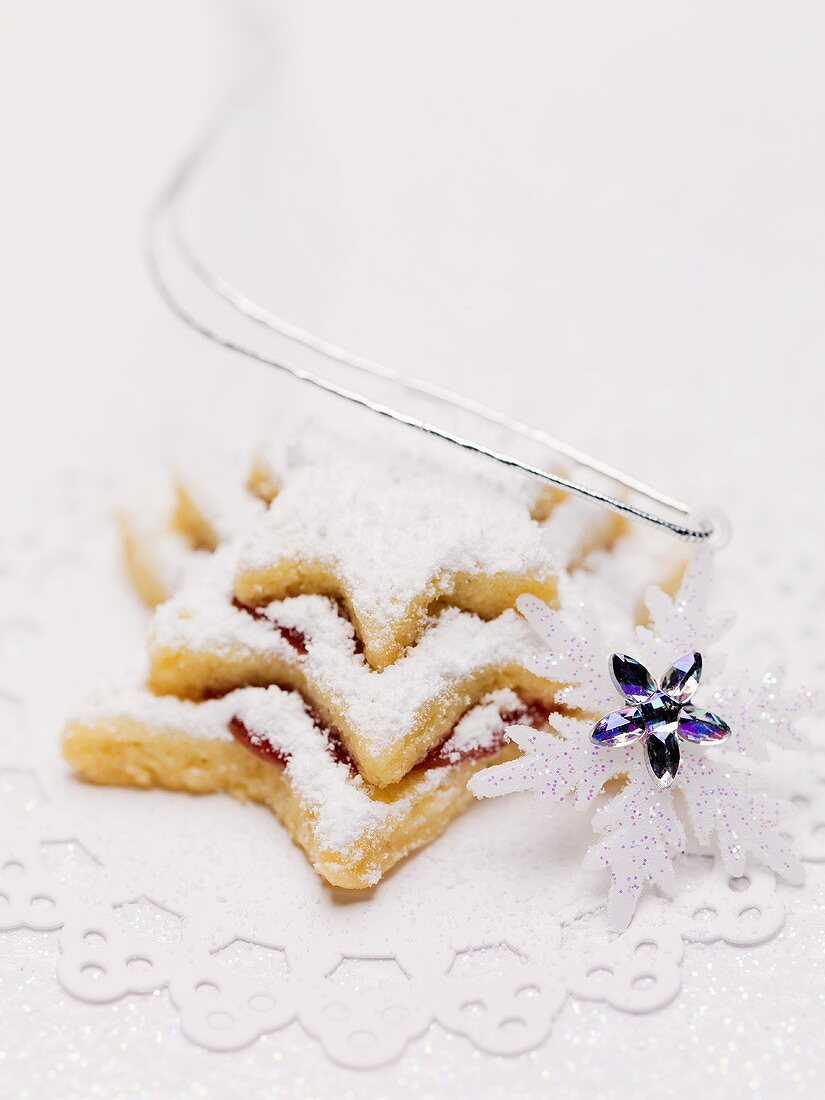 Star biscuits with jam and icing sugar