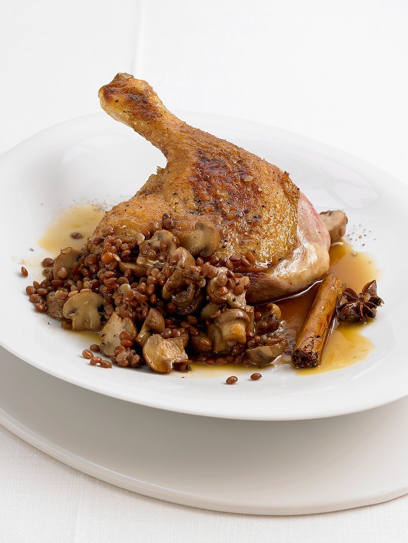 Duck leg on balsamic lentils with shallots and button mushrooms