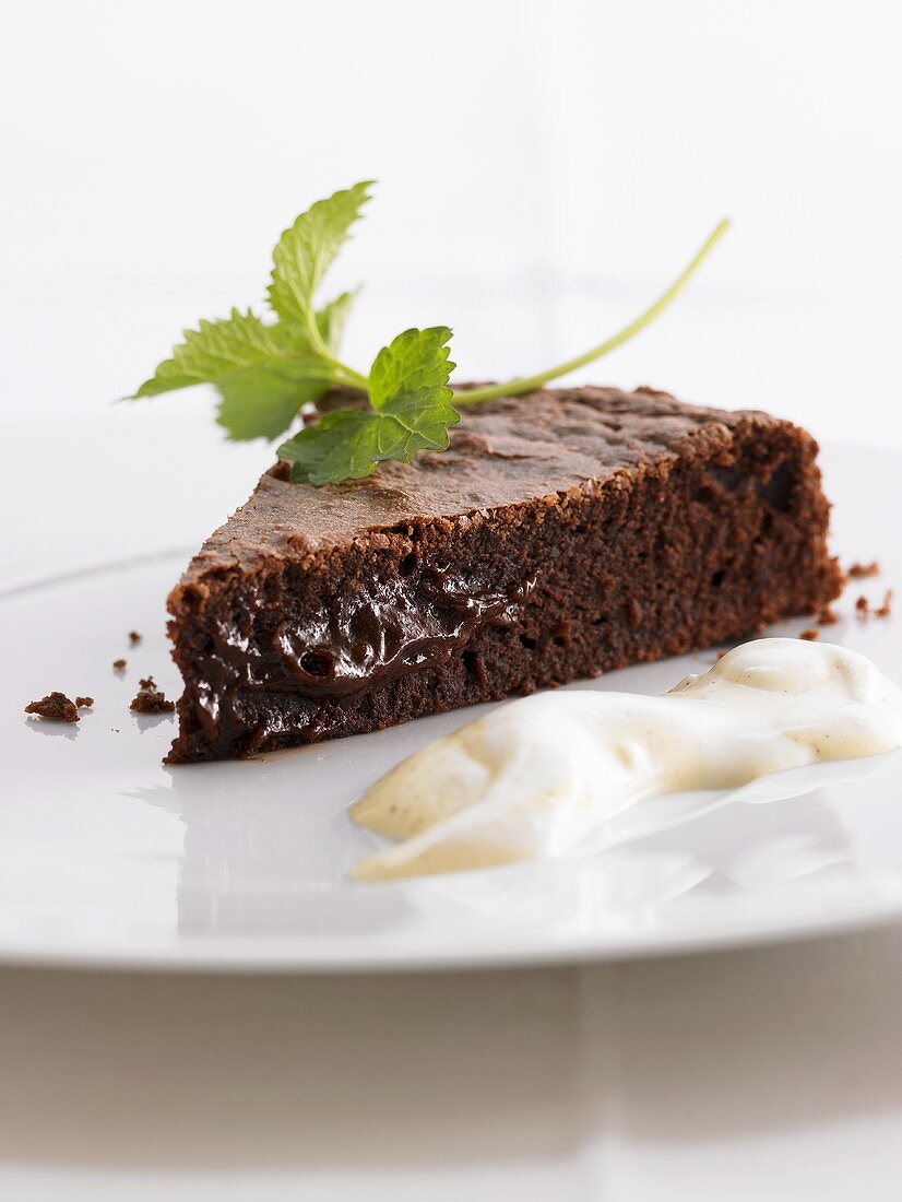 A piece of chocolate cake with custard