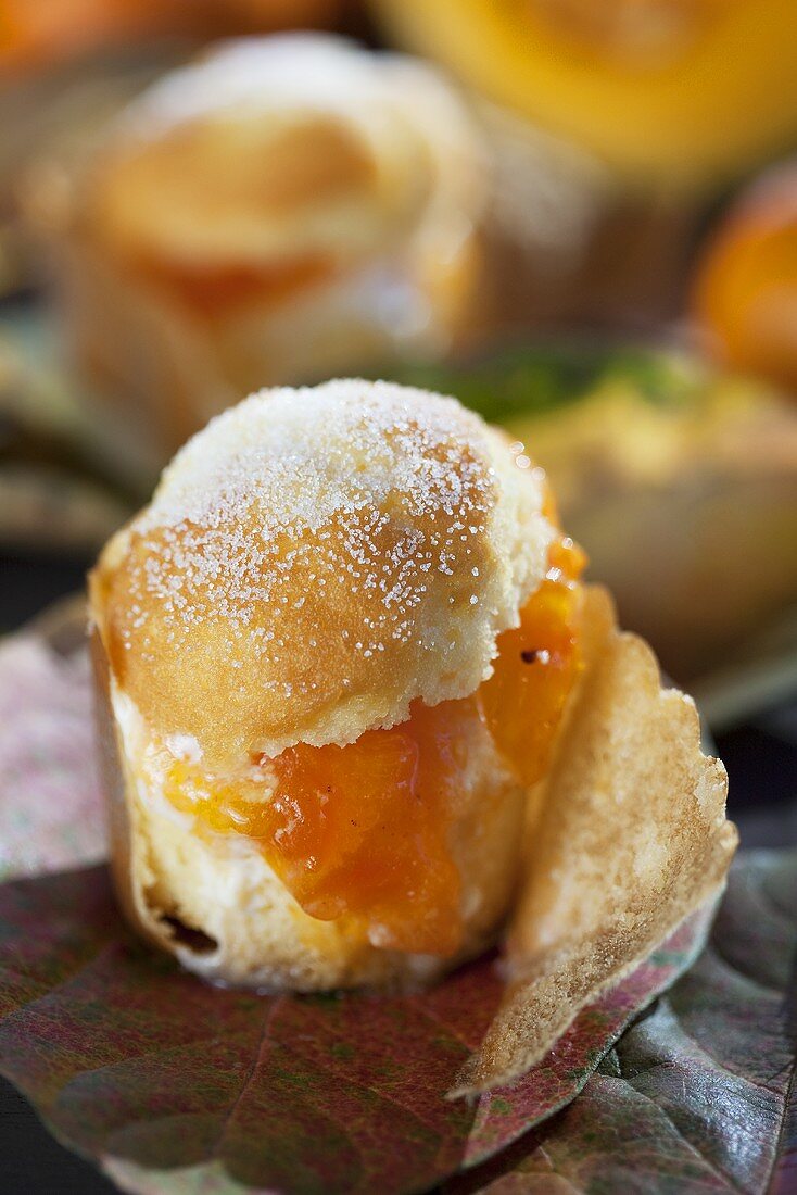 A muffin with Japanese persimmon and pumpkin jam on autumnal leaves