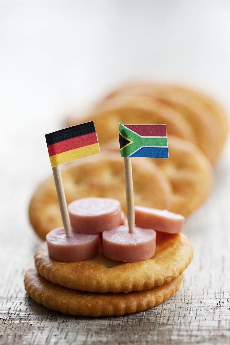 Crackers with sausage slices and flags