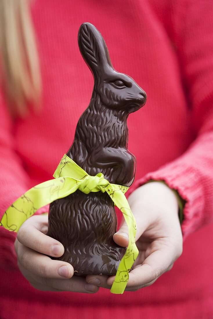 Girl holding chocolate Easter Bunny