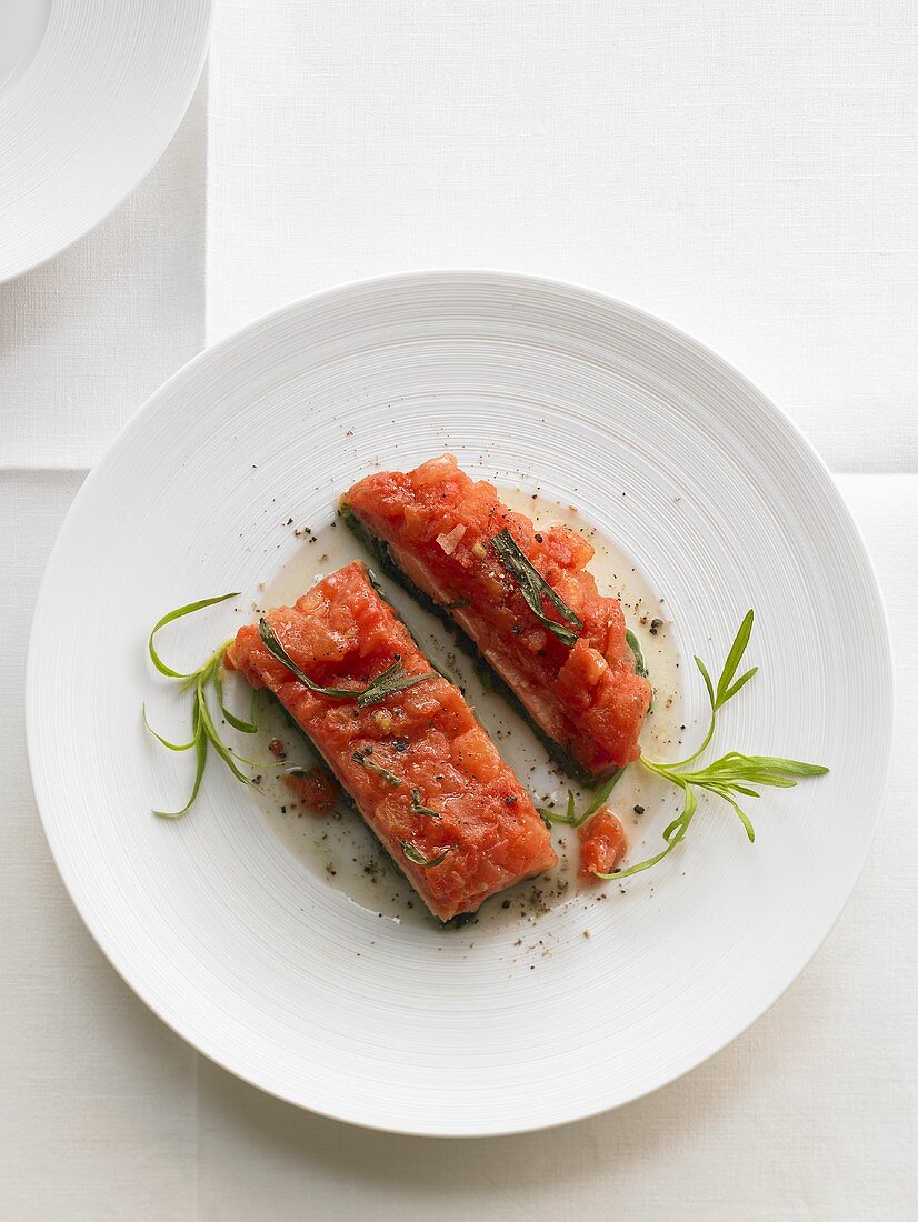 Salmon trout with tomato ragout on spinach